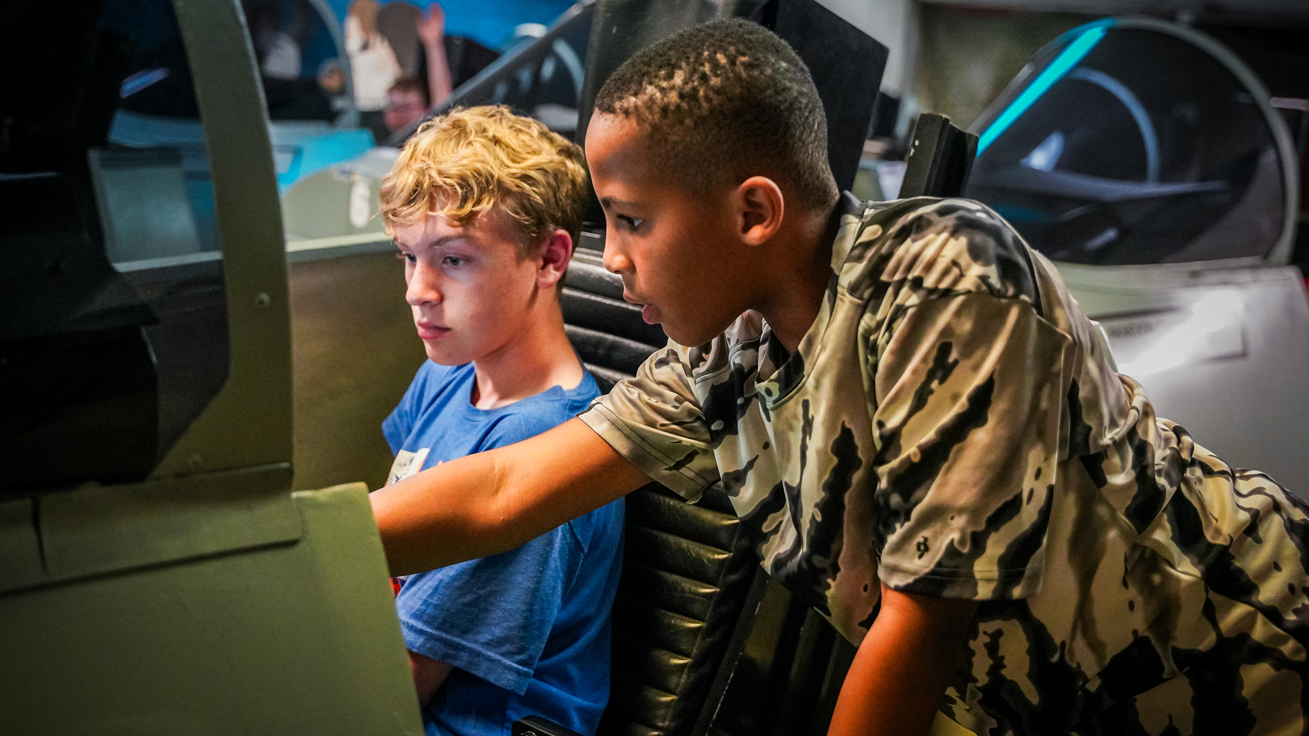 Two students in an Aviation Challenge simulator